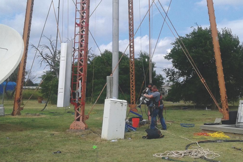 Workmen make preparations for scaling the “Bronco” water tower in Roosevelt and inspecting its dilapidated roof.