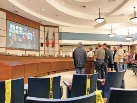 Gaylord News photo Bipartisan group Unite Norman stood in favor of electing Sean Boyd as an interim council member in place of David Perry. The group loudly protested the outcome of the vote against Boyd, calling council members cowards, tyrants and gutless.