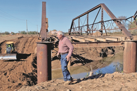 Ledger photo by Mike W. Ray Comanche County District 1 Commissioner Gail Turner inspects the progress on replacement of an aged, narrow steel truss bridge that spanned Cache Creek on Coombs Road southeast of Lawton. The wooden deck of the bridge has been removed and the steel frame will be torn down, making room for construction of a longer and wider steel-reinforced concrete bridge.