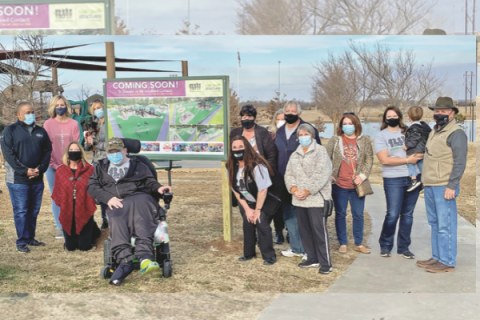 Ledger photos by Curtis Awbrey         Members of Children United Southwest Oklahoma attend a sign dedication at the site of a planned all-inclusive playground at Elmer Thomas Park in Lawton. Supporter Rocko Bonacci, in front of the sign, says the playground “is all about freedom.”