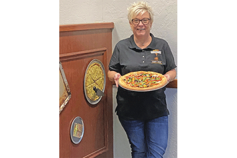 Ledger photos by Curtis Awbrey Jennifer Fortenbaugh, co-owner of Cabo Taco Cocina Mexicana and No Name Pizza, holds one of No Name’s popular pies, an Everything but the Kitchen Sink pizza.