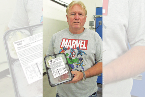 Ledger photo by Mark Potter James Bennight, CEO of Grannas Food Processing in Frederick, is pictured with a meal produced by the firm’s employees. The meals are sold and distributed to senior citizens’ centers, hospitals, nursing homes and other institutions.
