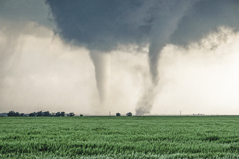 In this undated photo, a pair of tornadoes run through farmyards near Cherokee in northern Oklahoma.