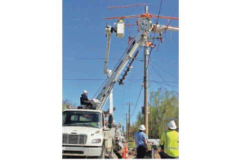 LEDGER PHOTO BY KYLETTA RAY  Contract linemen with Public Service Co. of Oklahoma replace a section of a 7,620-volt power line along 7th Street north of Gore Boulevard in Lawton last month.