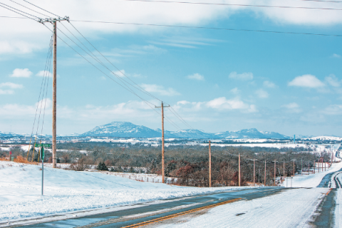 FILE PHOTO BY BRAYDEN THOMAS Utility poles line NE Jake Dunn Road in Elgin following February’s winter storm in Oklahoma.
