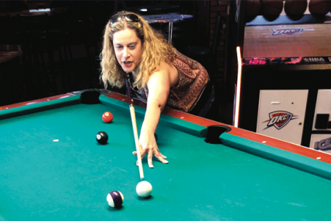 Jessica Cassidy shoots pool at Red Dirt bar and Grill. Photo by Tim Farley 