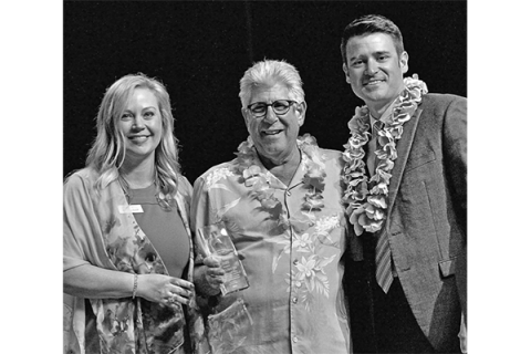 LAWTON-FORT SILL CHAMBER OF COMMERCE PHOTO Dr. Krista Ratliff, left, president and CEO of Lawton-Fort Sill Chamber of Commerce, and Mark Scott, right, board chairman, present the Lifetime Achievement honor to Eddie Hamra on behalf of Edward’s Men’s Wear.