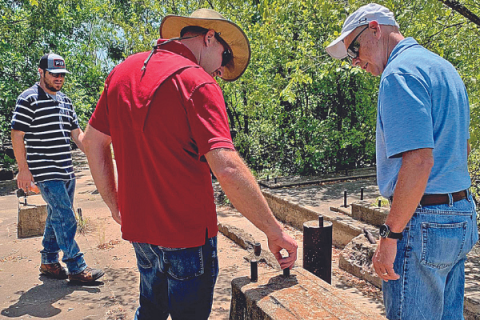 LEDGER PHOTO BY MIKE W. RAY This abandoned well site northeast of Velma, off County Line Road, was once a pump station; crude oil was pumped from here into a pipeline or a battery of tanks somewhere. The site was approximately 90 years old. Inspecting the site in July 2019 were, from left, Roger Walkup, project leader, and Rodney Troglin, project manager, both with Beacon Environmental; and Steve Sowers, environmental director with the Oklahoma Energy Resources Board.