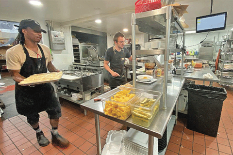 LEDGER PHOTO BY CURTIS AWBREY The Silver Spoon’s Andre Washington, left, carries freshly baked and buttered biscuits out as Kalib Polland presents a dish of curry beef. The Silver Spoon’s owner, Vera Oldham, was presented the Rising Star award by the Lawton-Fort Sill Chamber of Commerce during its June banquet.
