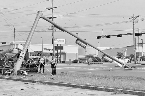 PHOTO BY KSWO-TV             Lawton police officers examine one of the vehicles involved in a fatality accident at 67th and Cache Road on  July 18.