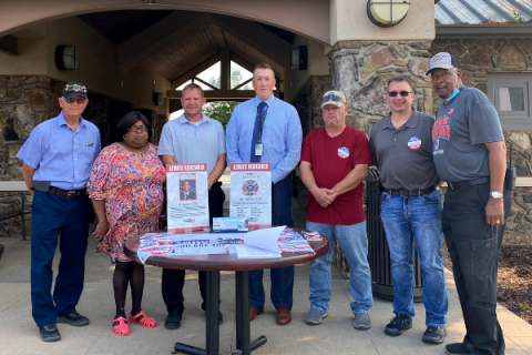 Matthew Priest, center, assistant manager of the Fort Sill and Fort Gibson National Cemeteries, stands with cemetery volunteers following a ceremony remembering the Sept. 11, 2001, attacks on the United States. KYLETTA RAY/LEDGER PHOTO