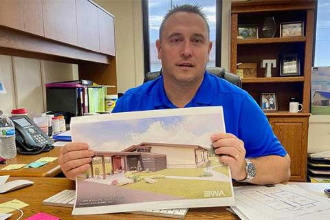 Flower Mound Public School Superintendent Dax Trent displays an artist's rendition of the district's proposed early childhood center in this Oct. 13 photo. The district is asking voters to approve a $2 million bond issuer to help cover the district's share of the project's cost, estimated at $2.8 million to $3 million.