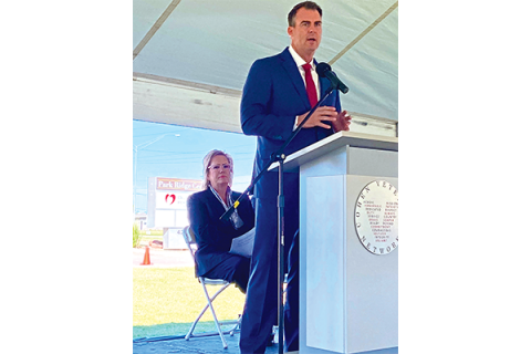 Red Rock Behavioral Health Services CEO Verna Foust (at back) listens as Gov. Kevin Stitt addresses the audience at the Oct. 21 grand opening for the Steven A. Cohen Military Family Clinic at Red Rock in Lawton. The clinic serves post-9/11 veterans, active-duty soldiers and their families. Eric Swanson/Ledger photo