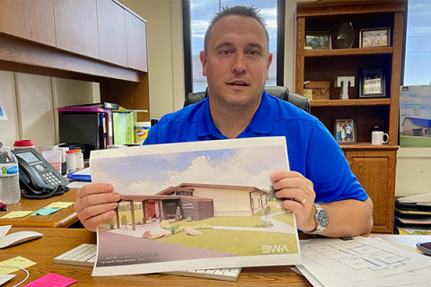 Flower Mound Public School Superintendent Dax Trent displays an artist's rendition of the district's proposed early childhood center during an Oct. 13 interview. Patrons of the district approved on Tuesday a $2 million bond issue to help cover the district's share of the cost, estimated at $2.8 million to $3 million. Eric Swanson/Ledger photo