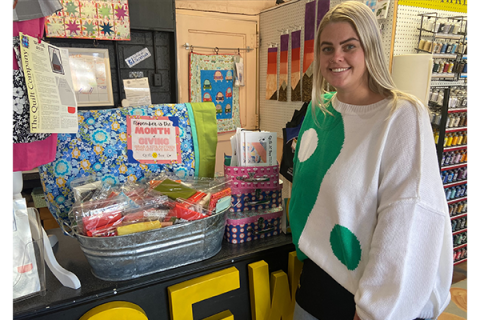 Mandy Martine-Ralston, shop manager of the Quilt N Bee store in Cache, poses next to a display of materials Tuesday at the store. Quilt N Bee has free kits and patterns available for people who would like to make pillowcases for foster children in need. Eric Swanson/Ledger photo