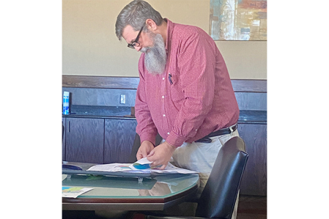 Paul Martin, planning technician for the city of Lawton, leafs through proposed ward maps before the Lawton Redistricting Commission’s Dec. 1 meeting. The commission is re-examining options for redrawing the city’s eight voting wards to account for population shifts. Eric Swanson/Ledger photo
