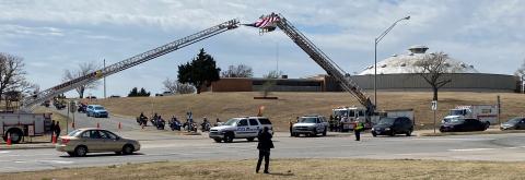 Vehicles depart from McMahon Auditorium on Tuesday after a memorial service for firefighter April Partridge of Apache. LEDGER PHOTO/CURTIS AWBREY