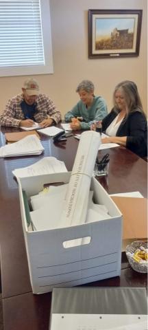 Hochatown residents Todd McDaniel, Dian Jordan and Sharon Ward finalize the town’s petition for incorporation last week. Residents of the small southeastern Oklahoma town have been pushing for years to incorporate. The small town is ground zero for tourists in southeastern Oklahoma.  Photo courtesy Dian Jordan