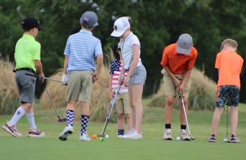 Dozens of children participate in a Junior Golf Association established at The Greens of Altus a couple of years ago.   Photos by Greg Daughterty