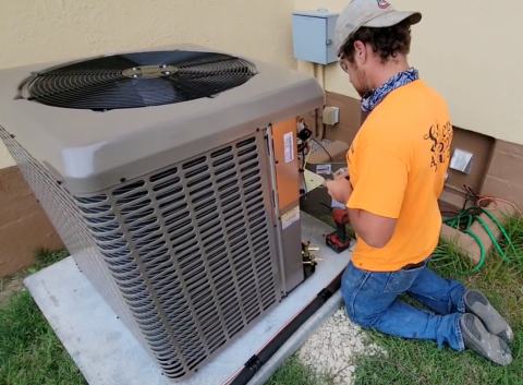 A technician at Fort Sill installs a new energy-efficient HVAC system as part of the $325 million Solutions Investment by Corvias to enable energy resilience and modernization across six Army installations.  Courtesy photo by Corvias