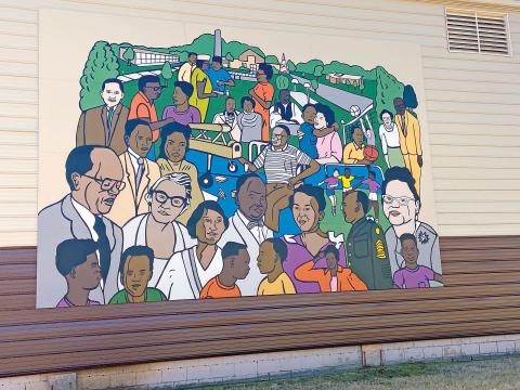 The restored Patterson Community Center mural is shown Friday. The City of Lawton hosted a media day Friday to showcase the mural, which depicts residents of the Patterson community and local landmarks.  Eric Swanson/Staff photo