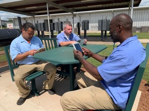 Oklahoma prison inmates, men and women alike, have been provided with electronic tablets that enable them to watch approved TV shows and movies and listen to music, and to access educational and employment resources – but especially provide access to their loved ones.  Photo provided by the Okla. Dept. of Corrections