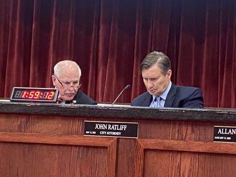 From the left, Lawton Mayor Stan Booker talks with City Attorney John Ratliff before the June 28 Lawton City Council meeting. The council approved allocations from the city’s hotel/motel tax proceeds for fiscal year 2023. Eric Swanson/Staff photo