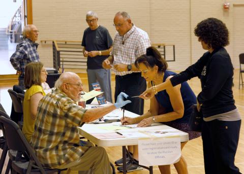 Residents line up to receive ballots at a Tulsa polling place during statewide primary elections June 28th Rip Stell/For Southwest Ledger