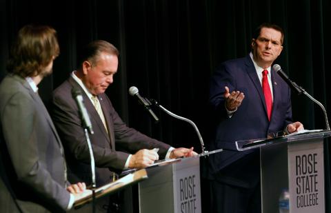 From left, Tres Savage, Editor-in-Chief of NonDoc.com, moderates a debate between former state Rep. Todd Russ and former state Sen. Clark Jolley at Rose State College last week. Russ and Jolley are vying for the Republican nod for the office of State Treasurer. LEDGER PHOTOS BY RIP STELL