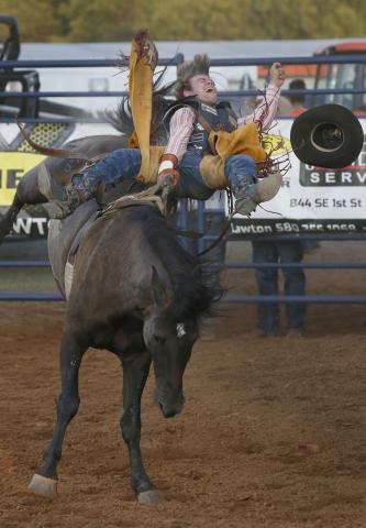 Bareback rider Gauge McBride rides his draw “Bad Influence” for the full 8 seconds Saturday night at the Lawton Rangers Rodeo. Rip Stell Staff Photo