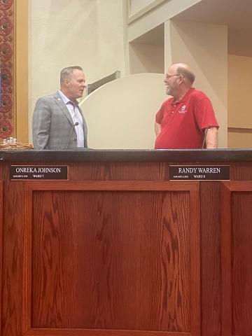 From the left, Lawton City Manager Michael Cleghorn talks to Lawton City Councilman Randy Warren before the council’s July 26 meeting. The council delayed action on the future of the city’s wading pools until a master plan for aquatic attractions is ready. Eric Swanson/Staff photo