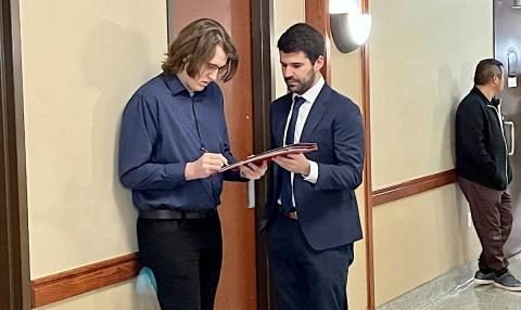 Zachary Milliren, left, signs a document with his attorney, Alex Courtney, at the Pontotoc County Courthouse on Thursday, Jan. 12, 2023. TRES SAVAGE | NONDOC