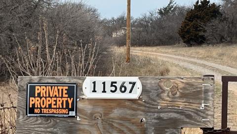 A sign posted at the entrance to Sun Light Farm, a marijuana grow operation several miles outside Sayre, warns visitors that beyond the gate is “Private Property: No Trespassing.”  The state recently stripped the farm of its operating license. KYLETTA RAY | SOUTHWEST LEDGER