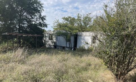 This abandoned trailer entwined in vegetation is one of 11 structures at Lake Chickasha that are scheduled to be demolished. CITY OF CHICKASHA
