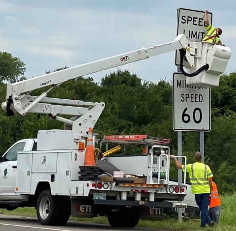 An Oklahoma Turnpike Authority crew member installs a new speed limit sign on the Norman spur of the H.E. Bailey Turnpike in August 2020. FILE