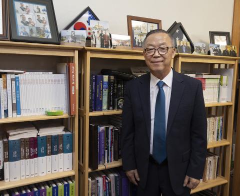 New Light United Methodist Church Pastor Ki Young Jeong stands in his office library. Jeong was instrumental in raising money for the Korean War monument built in Elmer Thomas Park. HUGH SCOTT JR. | SOUTHWEST LEDGER