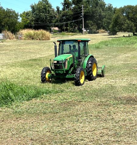 Chickasha Public Works Department employee Darryl Smith mows weeds in a field along the banks of Line Creek just north of West Illinois Avenue on August 10. MIKE W. RAY | SOUTHWEST LEDGER