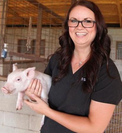 Holdenville veterinarian Dr. Rebekah Hartfield is shown with Rosie the Pig. OKLAHOMA STATE UNIVERSITY
