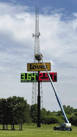 A workman who’s obviously not afraid of heights changes some burned-out bulbs in the Love’s sign at the convenience store off SH-49 north of Lawton near the H.E. Bailey Turnpike. Kyletta Ray | Southwest Ledger