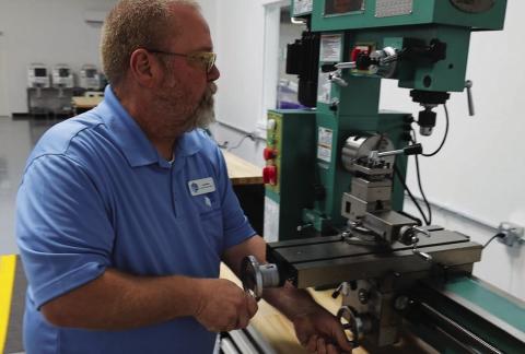 Provided An instructor at the new Manufacturing Skills Academy in Oklahoma City shows his students how to operate a manual lathe.