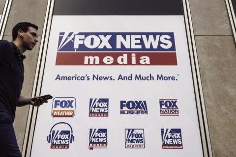 A person walks past the Fox News Headquarters in New York on April 12, 2023. AP Photo/Yuki Iwamura, File