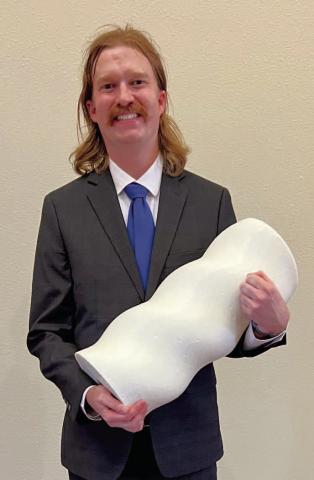 Kevin Lapp, engineering infrastructure manager for Firehawk Aerospace, holds a 35-pound sample of the company’s hybrid rocket engine propellant made with a 3D printer. Nitrous oxide (commonly referred to as “laughing gas”) is inserted in the middle of this material and ignited, and it burns “from the inside out,” Lapp said. Mike W. Ray | Southwest Ledger