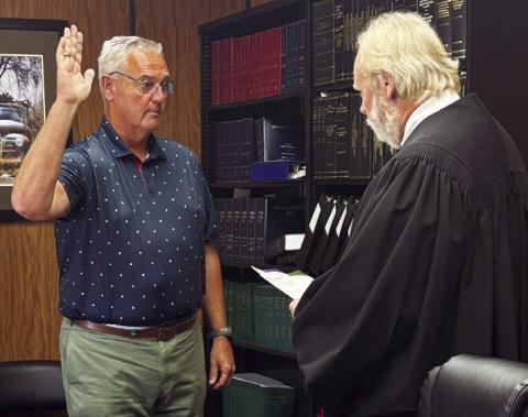 Provided Lawton native Brent Easton, left, who was recently appointed to the Comanche County Excise Board, receives the oath of office from District Judge Emmit Taylor.