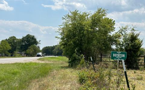 A northbound van travels out of the rural Muskogee County town of Boynton on Aug. 5, passing a sign bearing the town’s name. Curtis W. Awbrey | Southwest Ledger