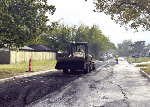 A T&amp;G Construction crew performs a deep asphalt patch on a residential street in Lawton on Nov. 7. City of Lawton