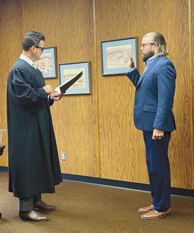 District Judge Grant Sheperd administers the oath of office to incoming Comanche County Commissioner Trent Logan during a June 3 ceremony in the commissioners’ chambers. Logan is taking over from District 1 Commissioner John O’Brien, who was suspended from office pending trial on three felony embezzlement charges and two misdemeanor charges. Eric Swanson | Southwest Ledger