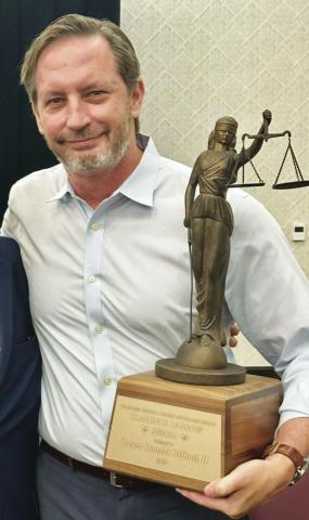 Robert Don Gifford holds the 2025 Clarence Darrow Award he received from the Oklahoma Criminal Defense Lawyers Association. Provided