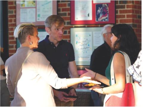Associate professor Carie Schneider, left, introduces author and researcher Angus Fletcher to journalism student Anjelica Martinez Thursday during Cameron University's Business After Hours event. Fletcher was the speaker for the latest installment of Cameron's academic festival, which is exploring the theme 'Being Human in the Age of Al.' Ashley Payne | Southwest Ledger
