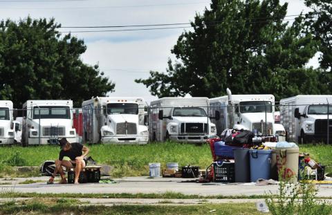 A man sits alongside his belongings on June 10 near Northwest 2nd and Lincoln Boulevard in Oklahoma City. Heather Warlick | Oklahoma Watch