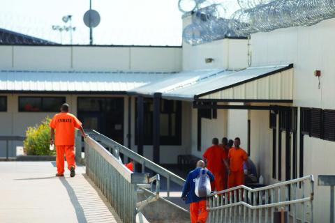 Prisoners move in a common area of the Joseph Harp Correctional Facility on Oct. 10, 2024. Brent Fuchs | Oklahoma Watch